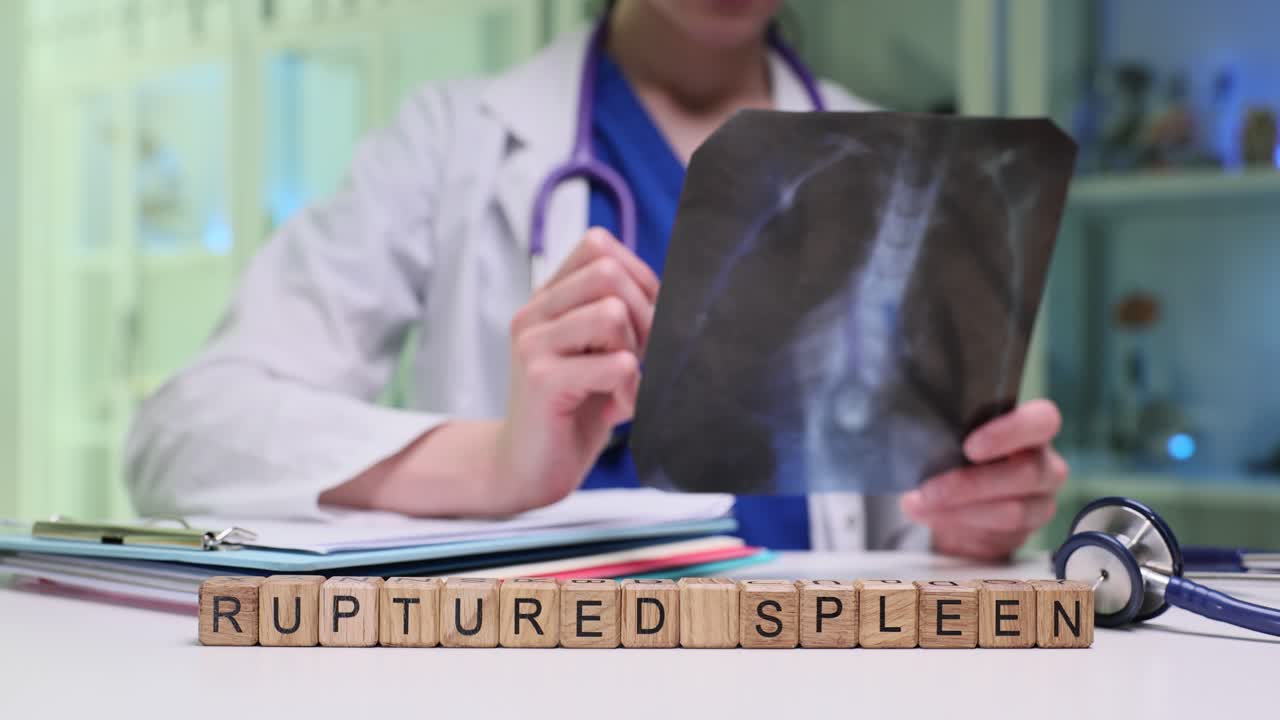 Wooden cubes spell phrase ruptured spleen on medical desk