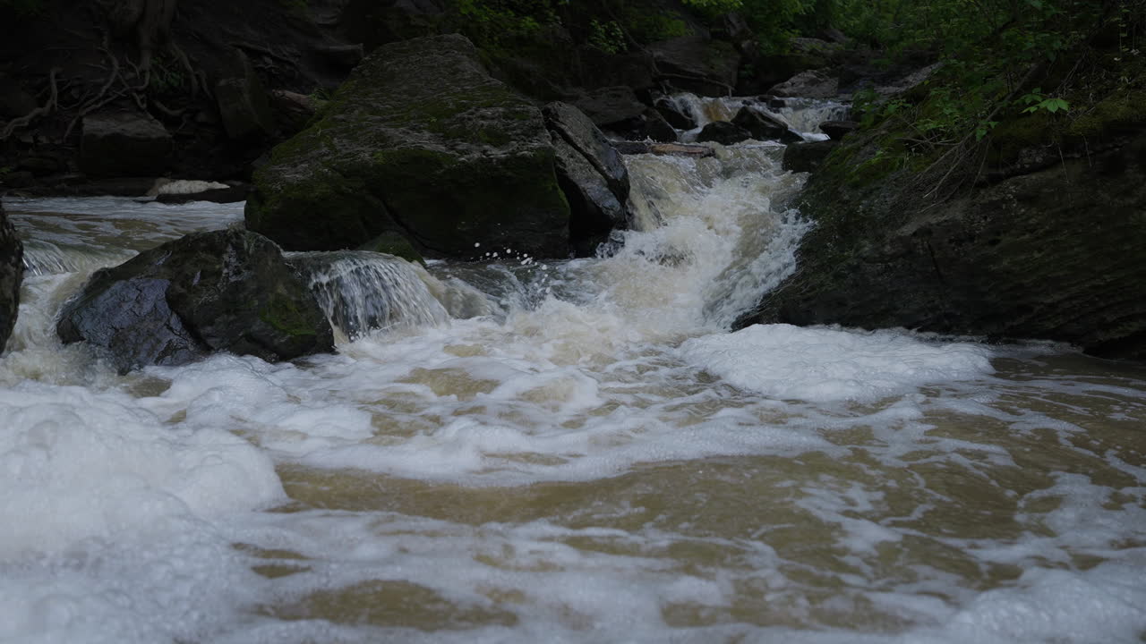 Rushing water over rocks at 15 Mile Creek, Niagara, creating a peaceful and natural atmosphere