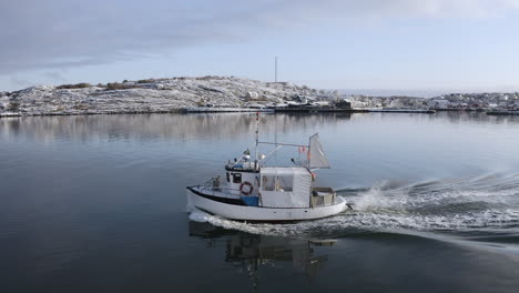 close-up shot of a small white fishing boat ship sailing on sea at öckerö island municipality in gothenburg archipelago, sweden