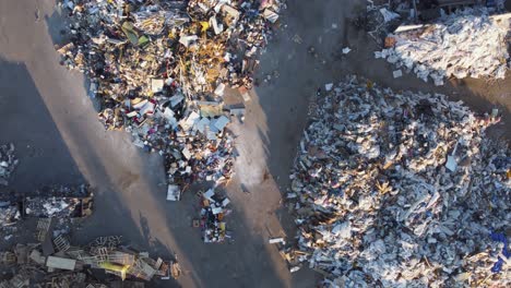 large piles of waste at a landfill site on a sunny evening