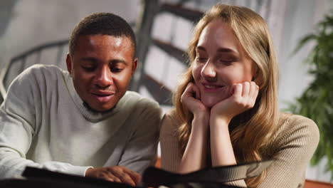 african-american guy and white woman enjoy old photos