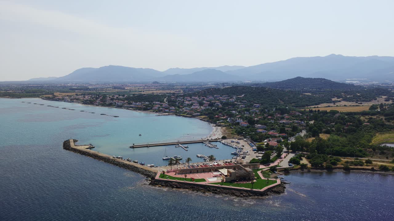 Marina of Pula, Sardinia, boats moored in tourist port, coastal town, Italy. Aerial drone