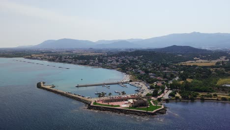 marina of pula, sardinia, boats moored in tourist port, coastal town, italy. aerial drone