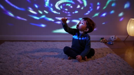 child captivated by colorful light projection