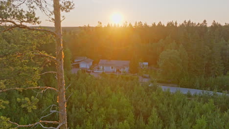 aerial tracking shot of a solar powered home in middle of countryside forest