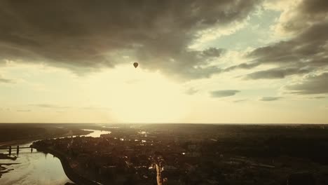 Aerial-view-of-hot-air-balloon-in-the-cloudy-sky-above-the-Kaunas-old-town