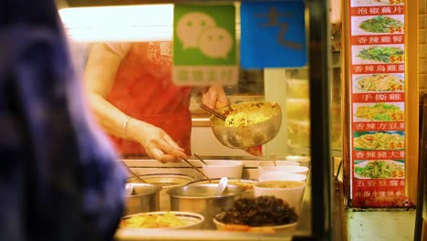 vendor preparing food at a busy stall