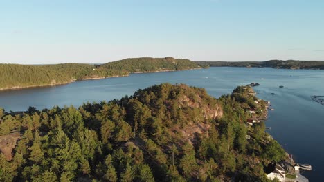 Beautiful-fishing-village-cabins-on-Norwegian-fjord-island,-aerial-view