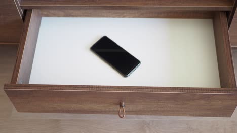 open drawer with a mobile phone