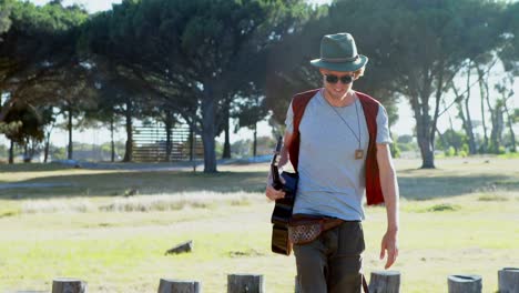 hombre con guitarra caminando en el festival 4k