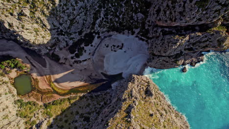 Top-View-Of-Sa-Calobra-Beach-And-Torrent-de-Pareis-With-Steep-Rugged-Cliffs-In-Mallorca,-Spain