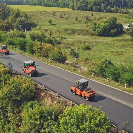 aerial view on the road rollers working on the new road construction site. road construction works.