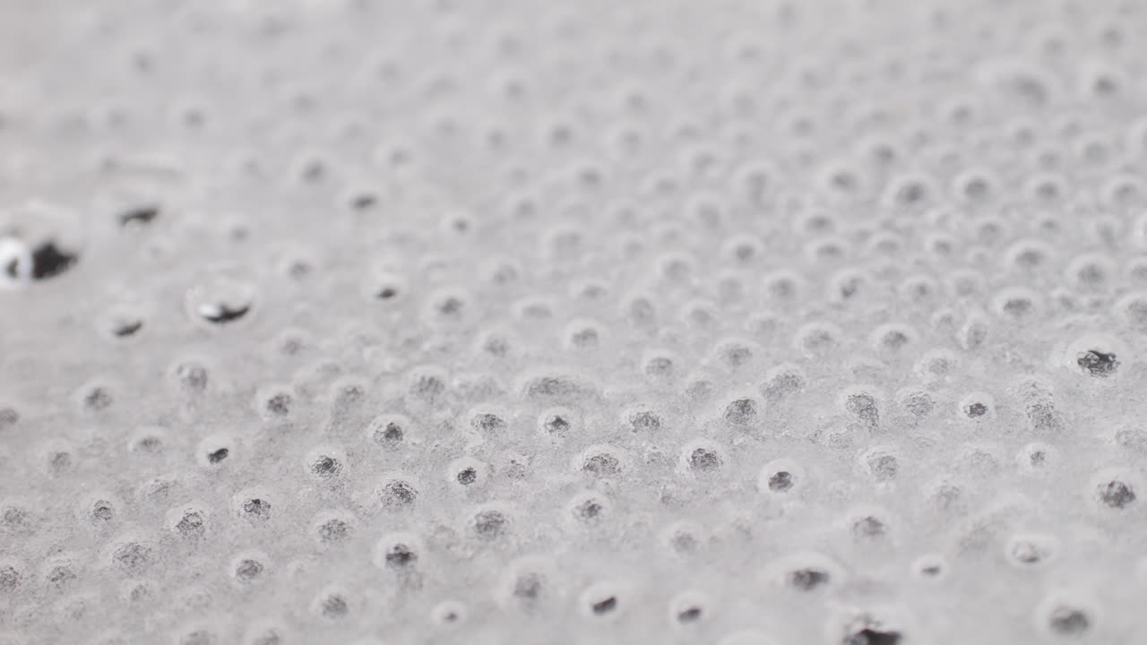 Close up of boiling sugar with bubbles turns into caramel, caramelization, chef cooking dessert in cafe, restaurant pastry food.