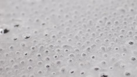 Close up of boiling sugar with bubbles turns into caramel, caramelization, chef cooking dessert in cafe, restaurant pastry food.