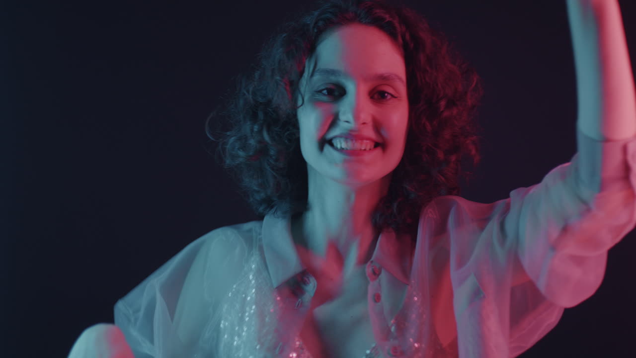 Woman Dancing Under Neon Light