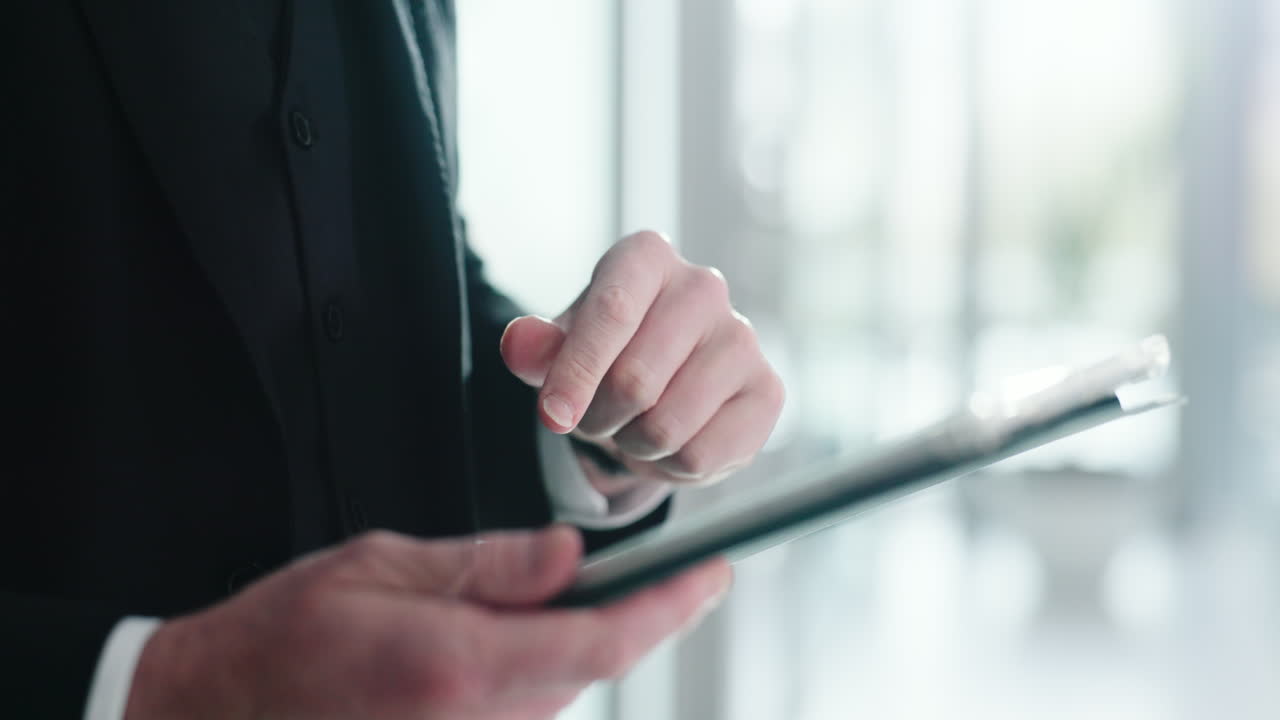 Man in suit using tablet