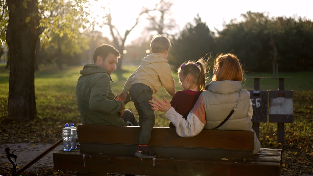 Family enjoying a sunny autumn day in the park