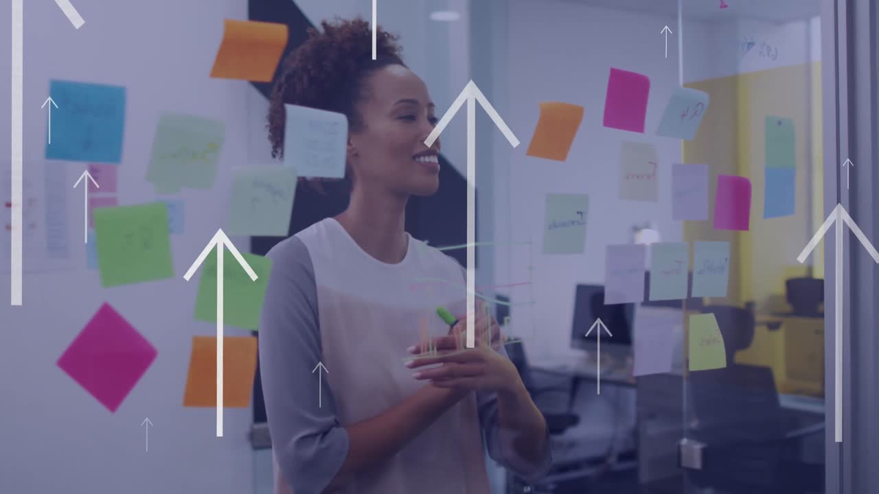 Animation of arrow icons moving upwards over biracial woman smiling looking at memo notes