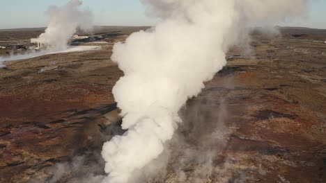 white gas rises from active volcanic geyser in iceland, gunnuhver