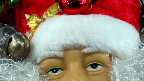 happy santa claus toy in a red hat with bells, big white beard, christmas decoration, traditional holiday presents, new year decor, shiny colorful decor, detailed close up tilt up shot, 4k video