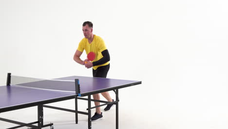 male table tennis player serving and passing the ball on white background, copy space