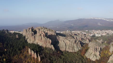 Pulling-out-aerial-drone-shot-of-the-natural-rock-formations-in-the-town-of-Belogradchik,-at-the-foothills-of-the-Balkan-mountain-range,-located-in-the-province-of-Vidin-in-Bulgaria