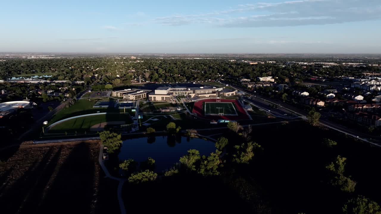 Greeley West High school establishing shot golden hour drone video 4k. 2024.