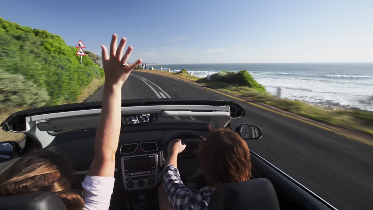 Couple driving convertible car cabriolet cape town south africa steadicam shot