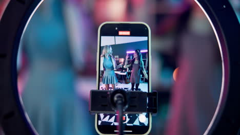 women recording a video on their phone