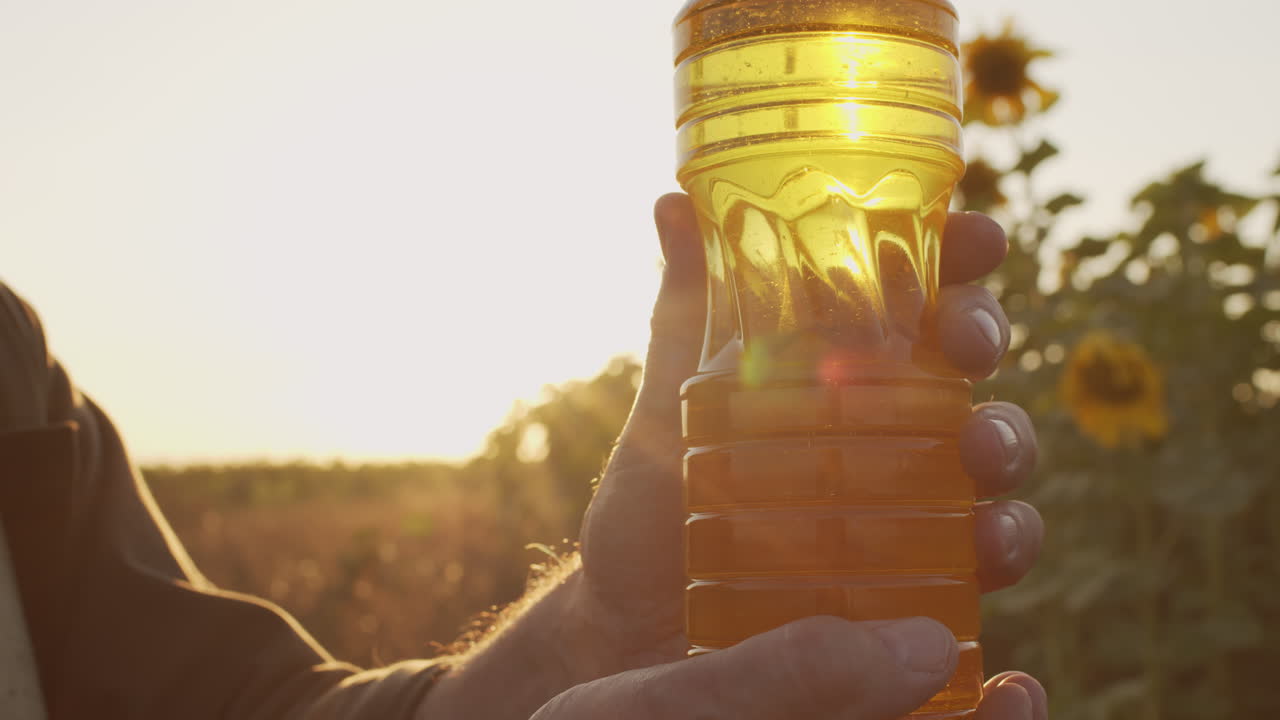 Man Holding Bottle Of Sunflower Oil