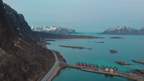 aerial drone shot of the ocean outside of lofoten norway, car road next to the ocean.
