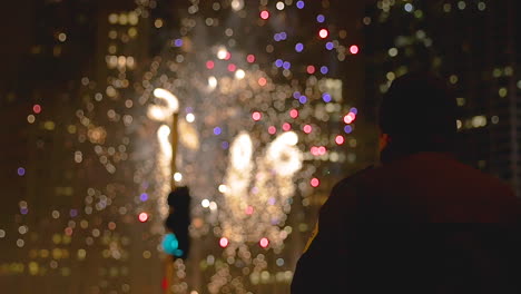 a police officer watches the fireworks finale in downtown chicago at the magnificent mile parade on michigan avenue