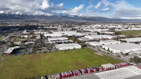 slow town view with field and mountains on the back with snow on top