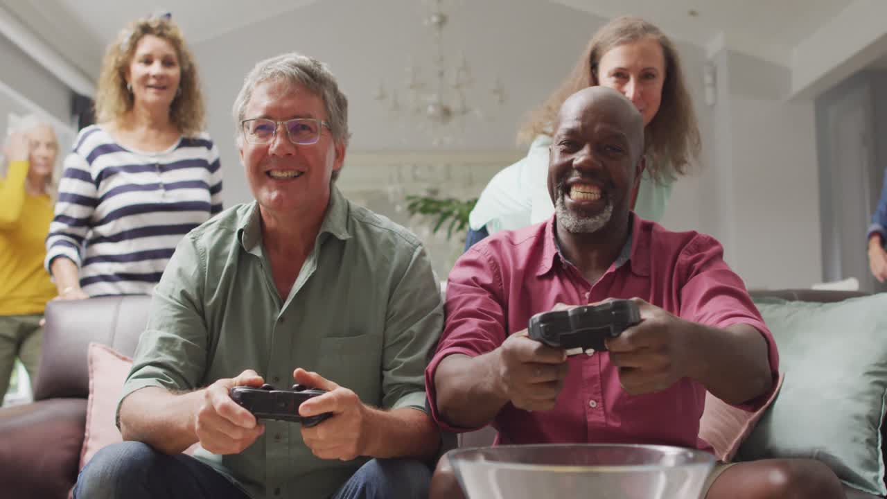 Animation of happy diverse male senior friends playing video games