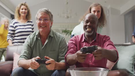 Animation-of-happy-diverse-male-senior-friends-playing-video-games