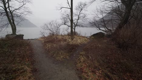 a beautiful, mysterious foggy and rainy day during autumn on the hudson river in new york, with the appalachian mountains in the background