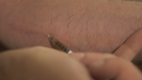 heroin addict injecting heroin using syringe