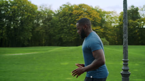 Sporty-man-jogging-in-green-park.-Runner-doing-cardio-workout-on-road