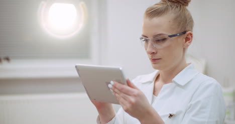 female doctor using digital tablet at dental clinic 3