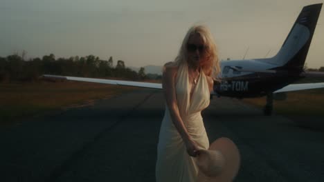 woman at an airport with a private jet
