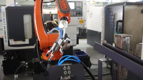 robotic arm putting a raw material on the machine. industry 5.0, industrial 4.0 concept