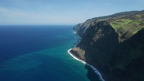 stunning blue atlantic ocean meeting steep rocky cliffs of madeira island