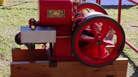 red vintage engine running smoothly outdoors