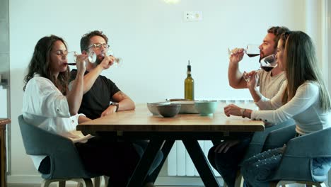 smiling friends cheering with wineglasses