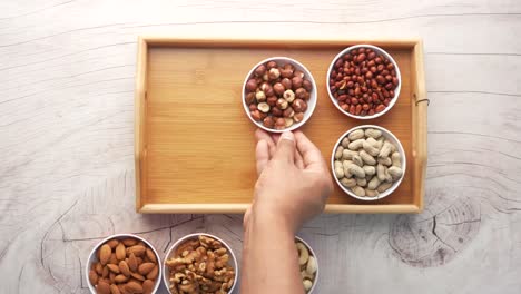 assorted nuts on a wooden tray