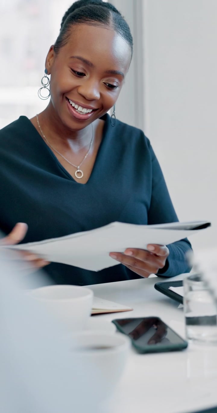 Professional Woman Reviewing Documents During a Business Meeting