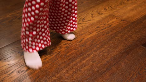feet of child dancing on wooden parquet floor