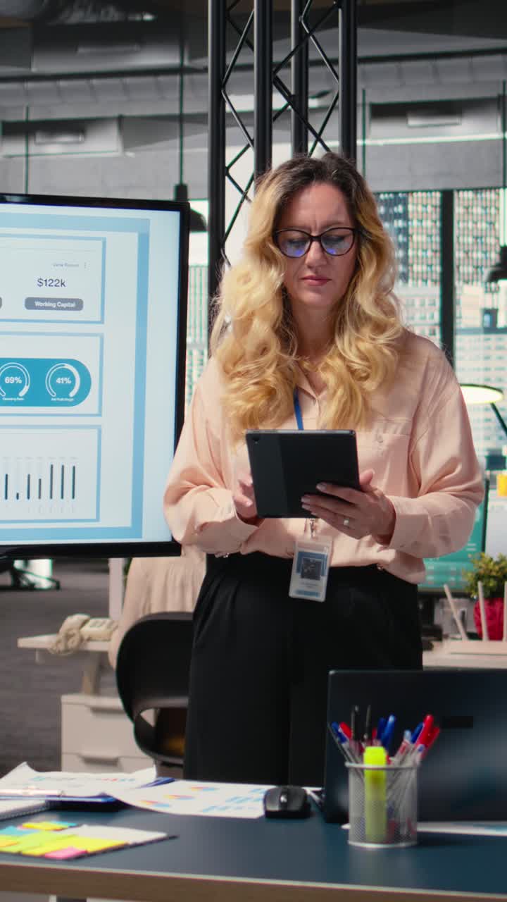 Vertical Video Chief executive officer evaluating productivity reports in company space