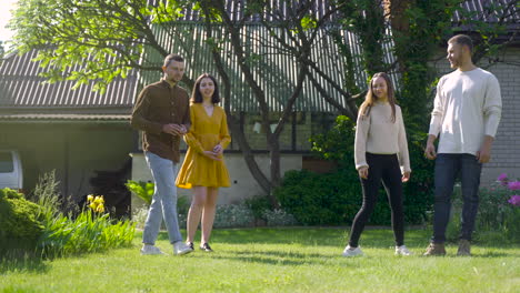 distant view of four caucasian friends playing petanque in the park on a sunny day