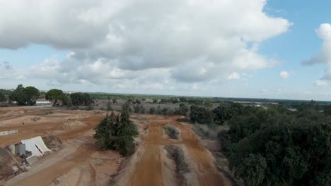 Aerial-dolly-of-empty-motocross-dirt-bike-track-on-overcast-day